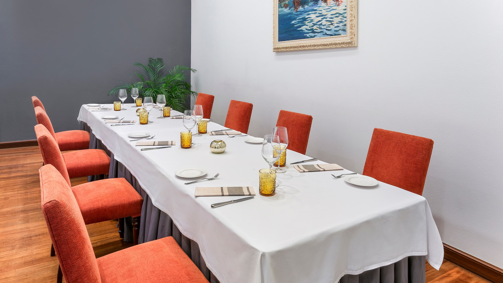 a long table with chairs and glasses on it