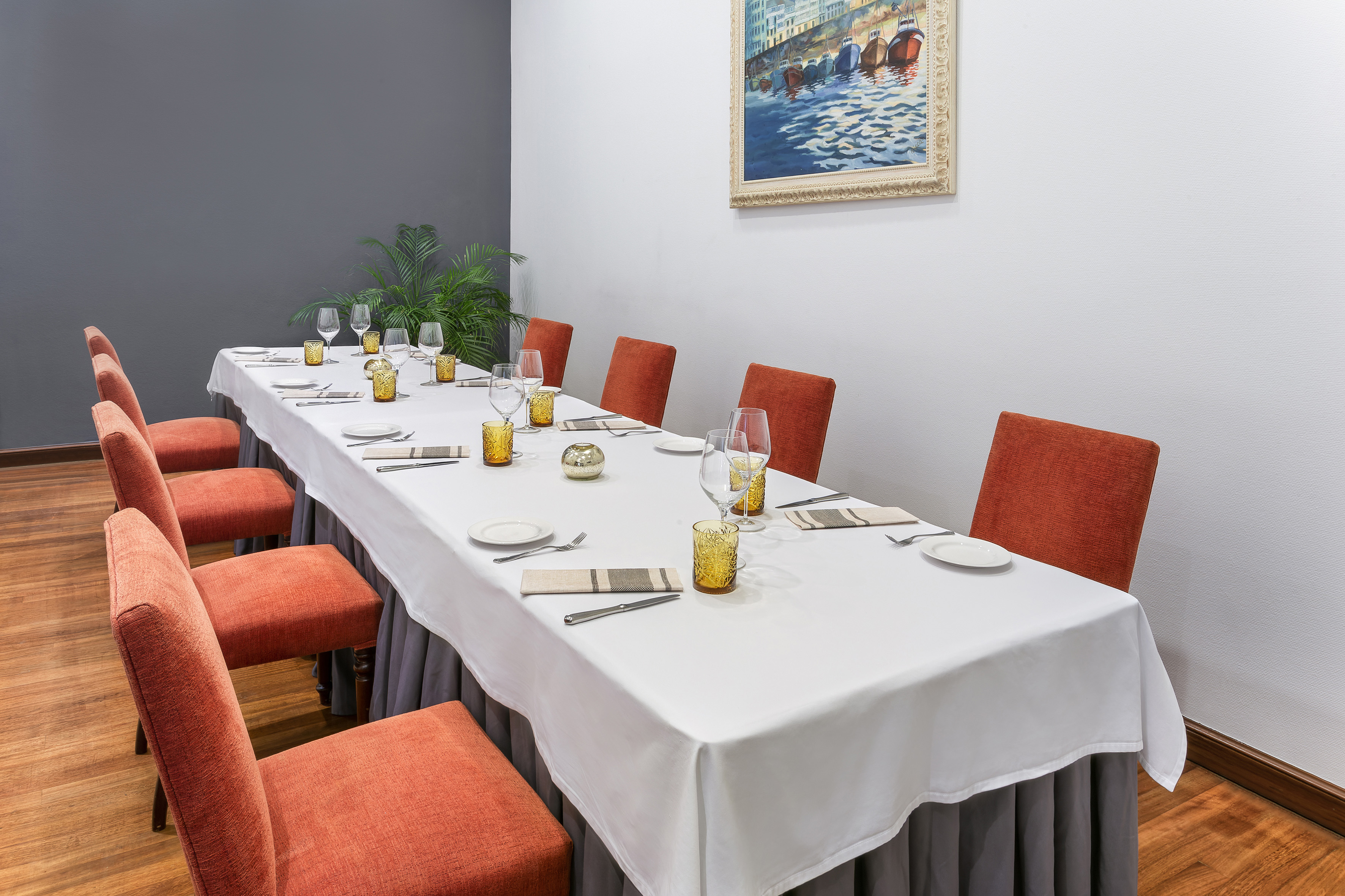 a long table with chairs and glasses on it