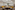 Flexible meeting room with yellow lounge, training tables, and modern lighting.