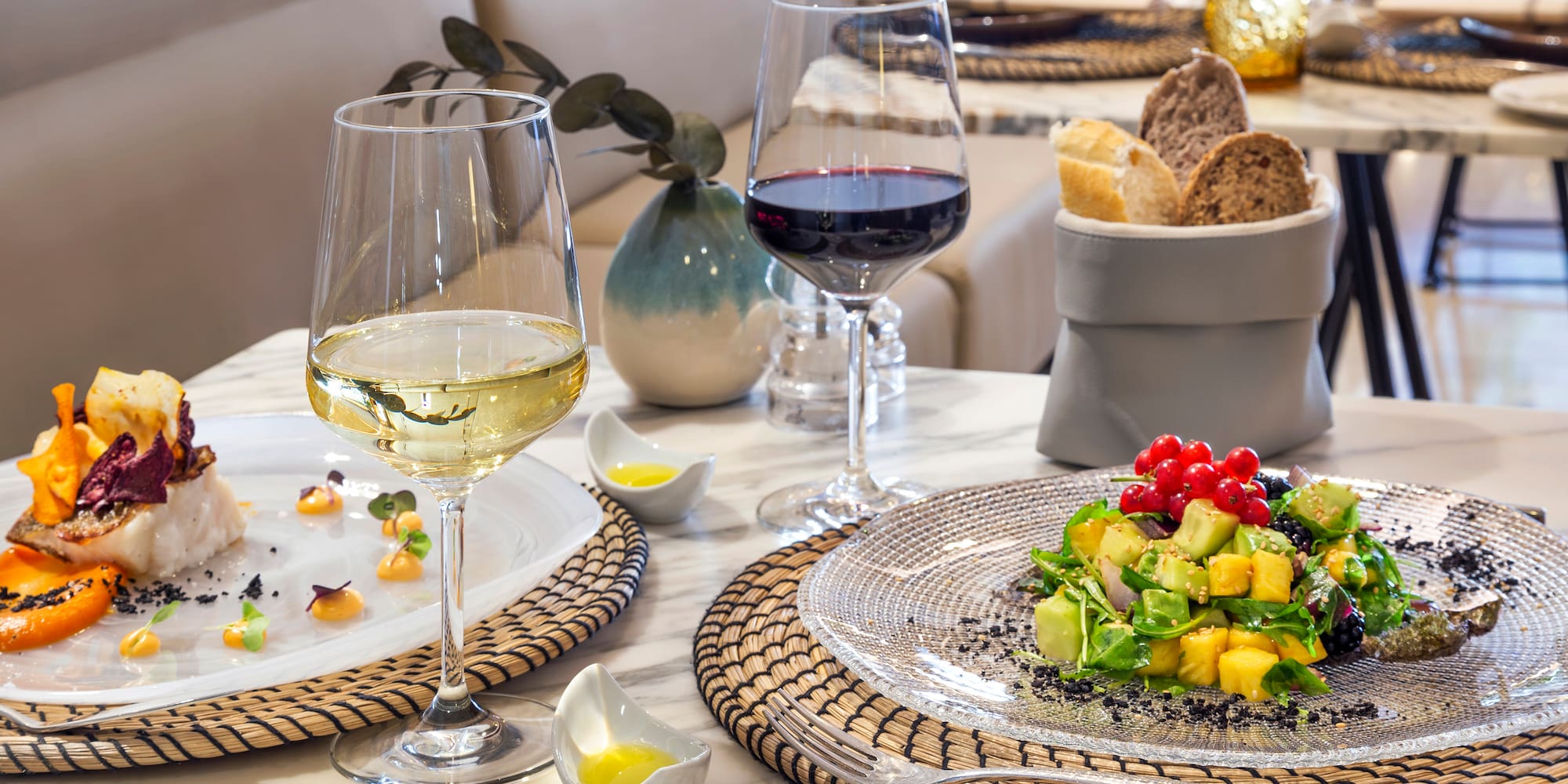 a plate of food and wine on a table