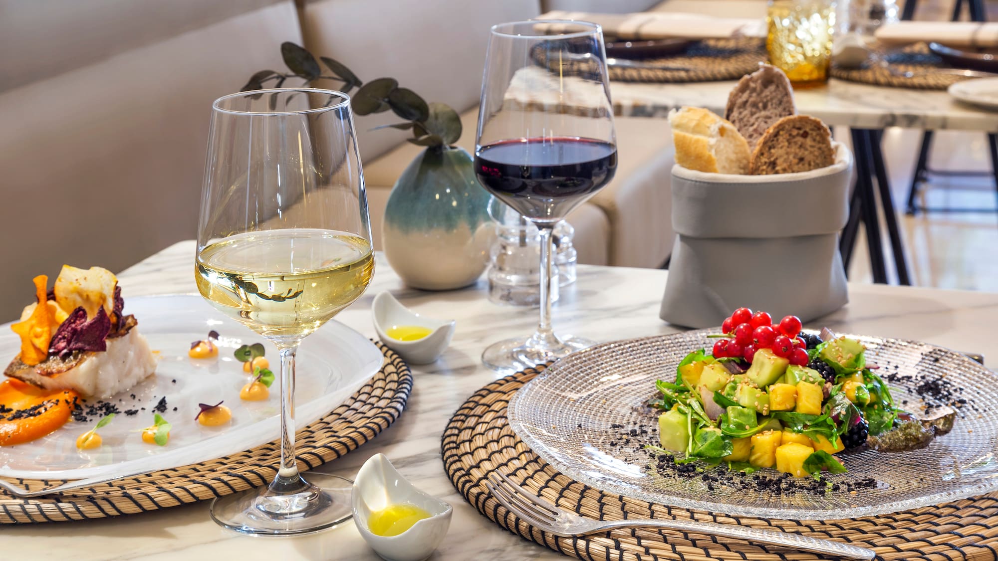 a plate of food and wine on a table