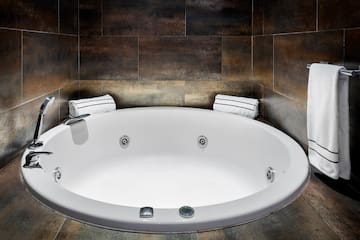 a white round bathtub in a bathroom