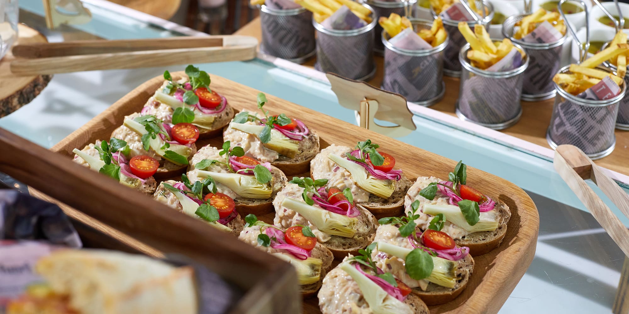 a tray of sandwiches with vegetables and meat on them