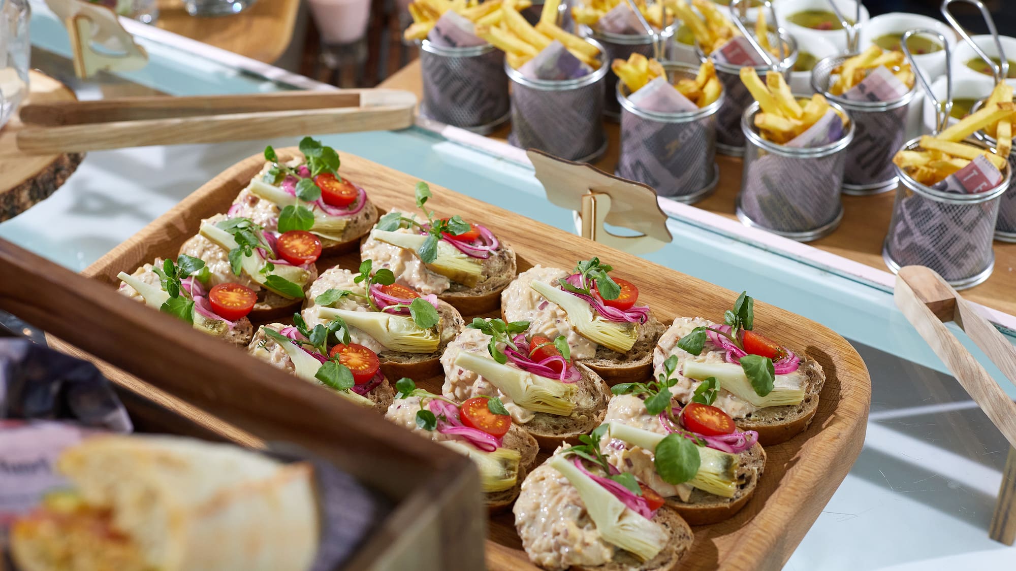 a tray of sandwiches with vegetables and meat on them