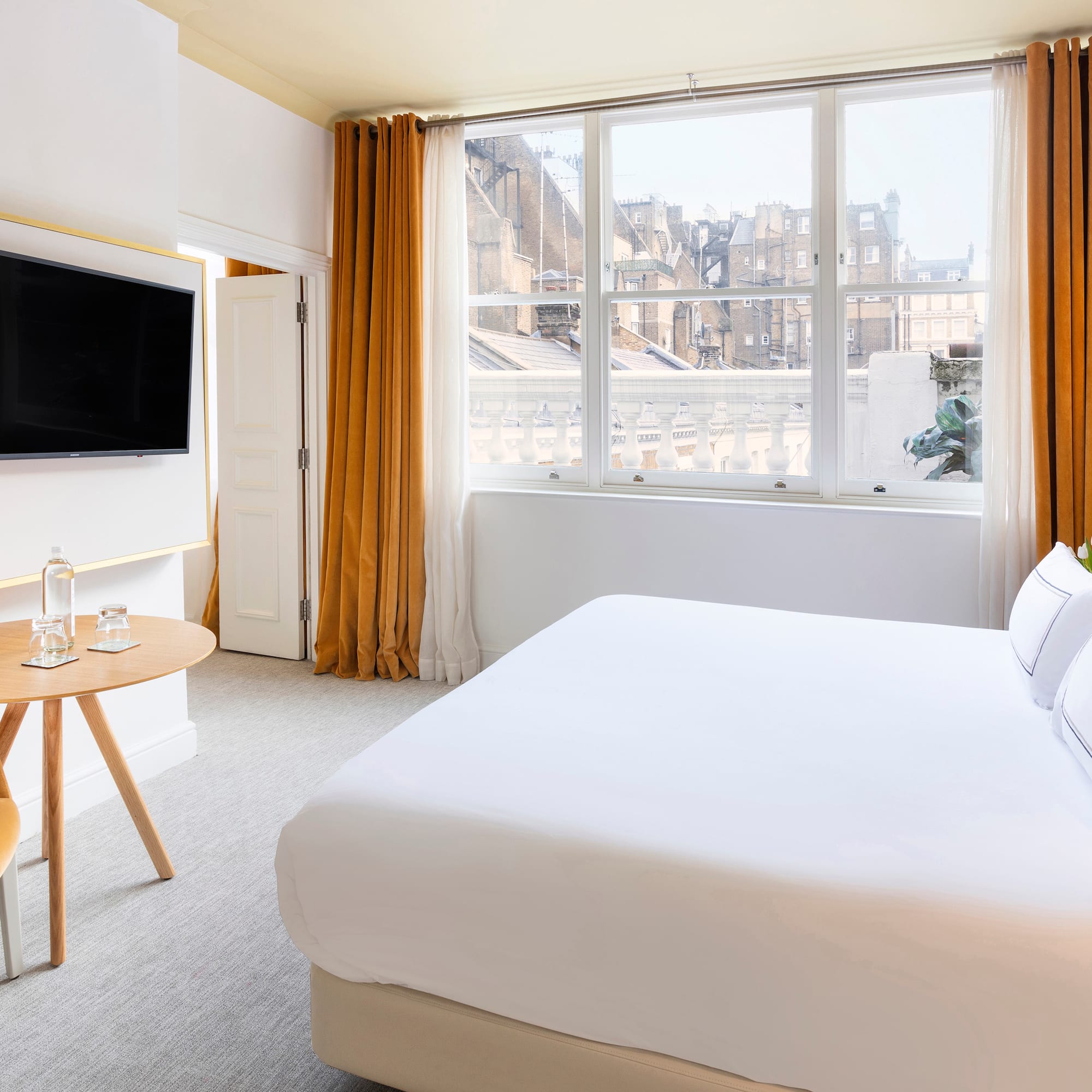 a room with a bed and a tv