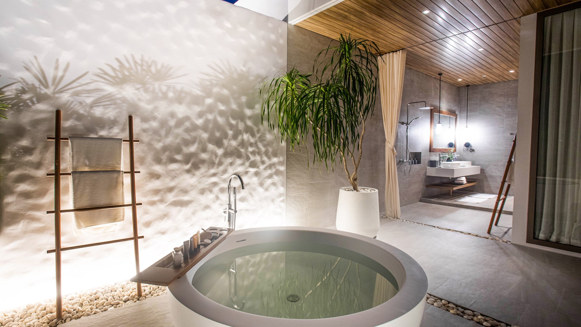 a bathtub outside with a plant