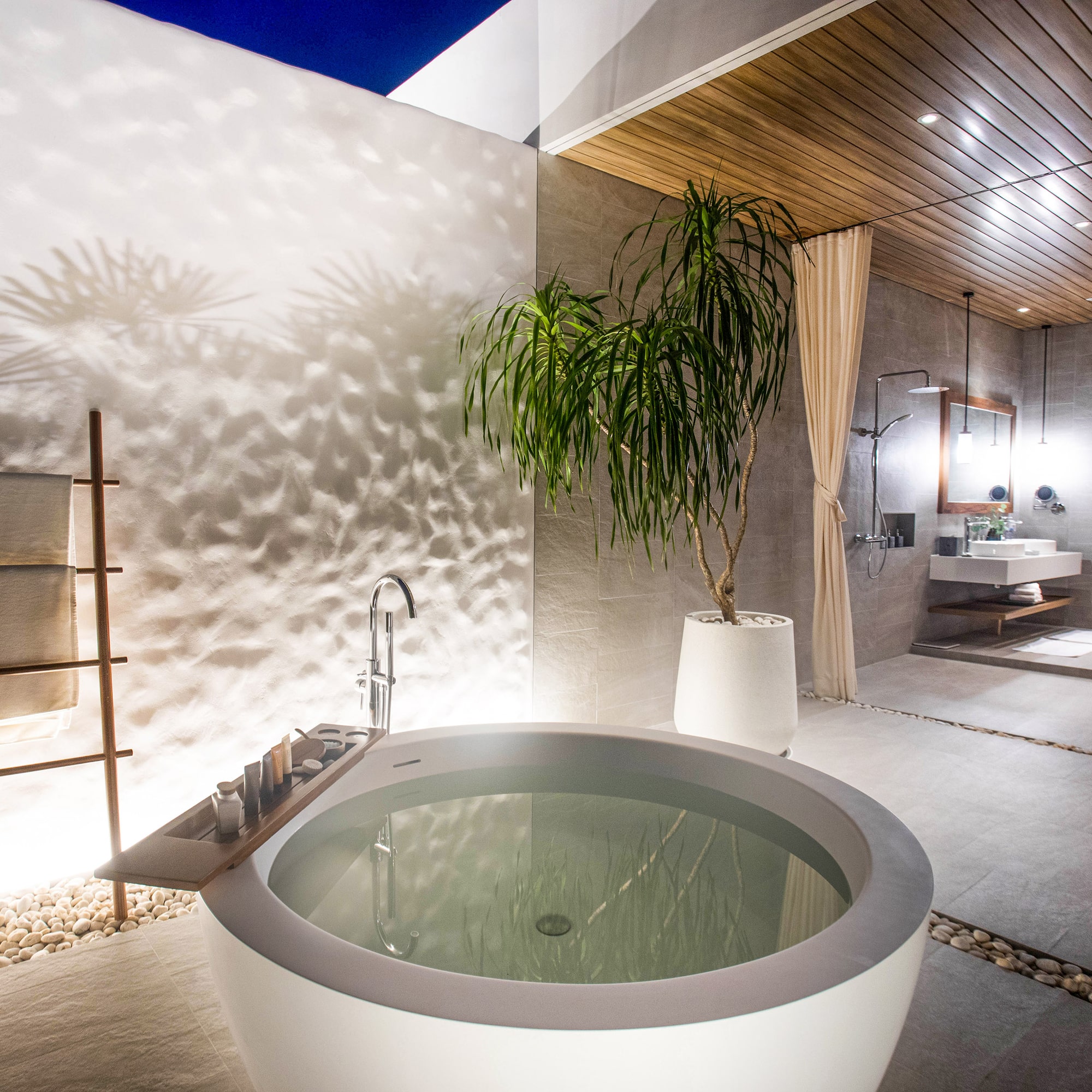 a bathtub outside with a plant