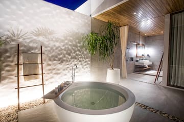 a bathtub outside with a plant
