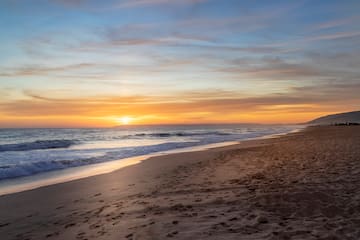 a beach with waves crashing on the shore