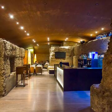 a room with a stone wall and a bar