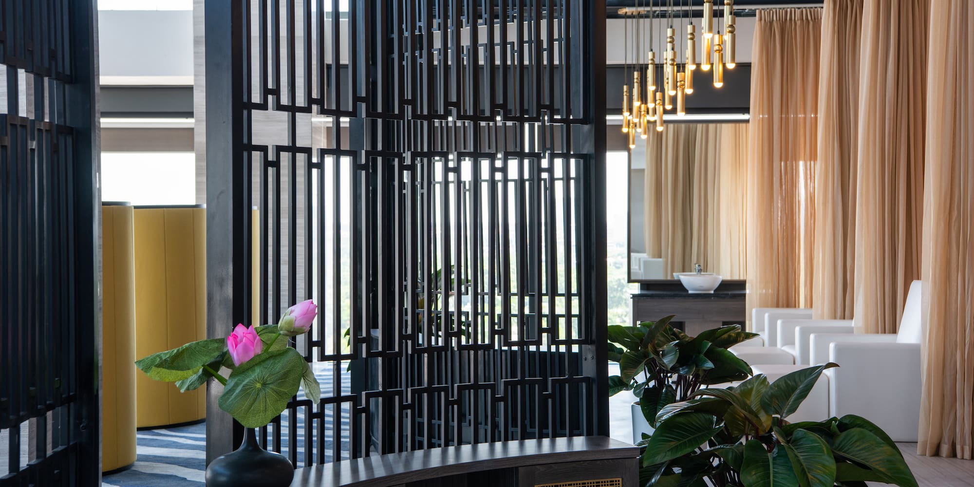 a room with a screen and plants