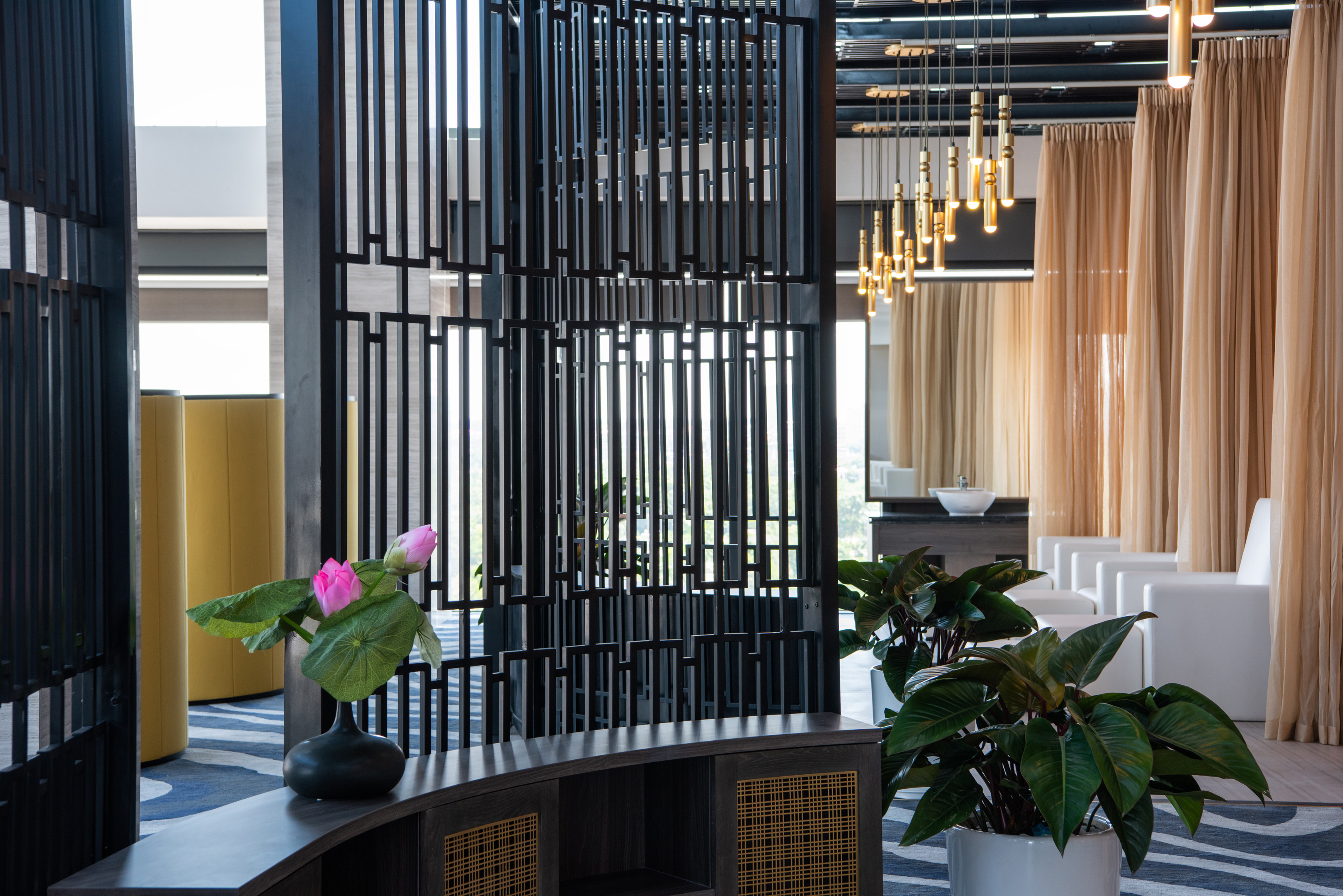 a room with a screen and plants