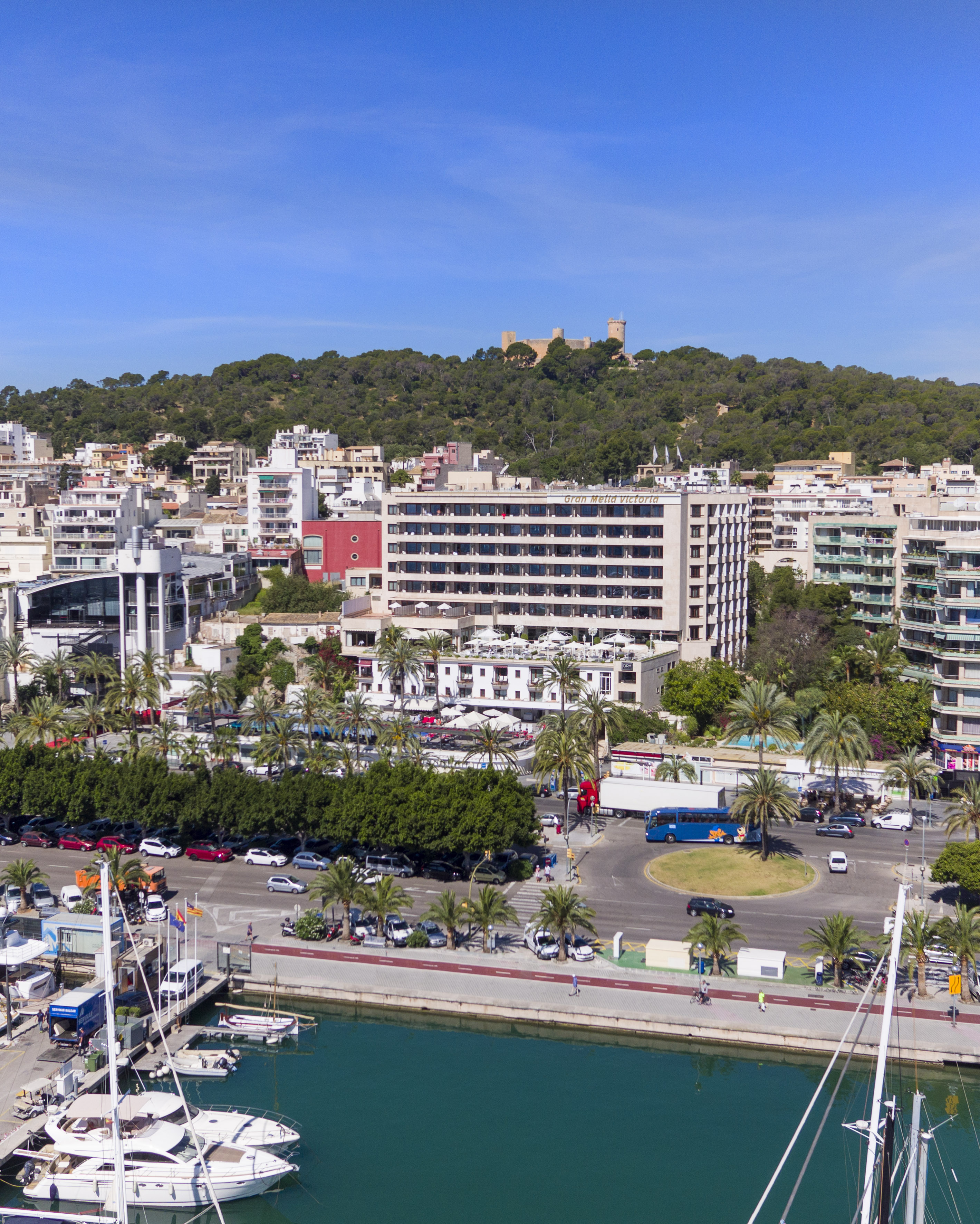 Palma de Mallorca marina, Gran Melia Victoria hotel, and Bellver Castle.