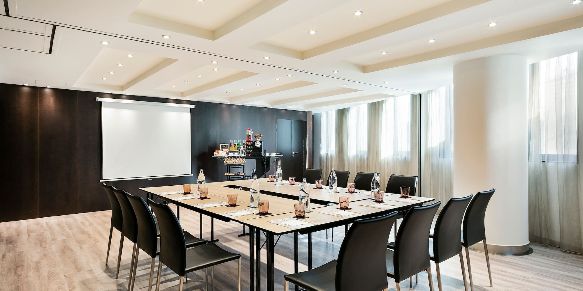 a conference room with a table and chairs