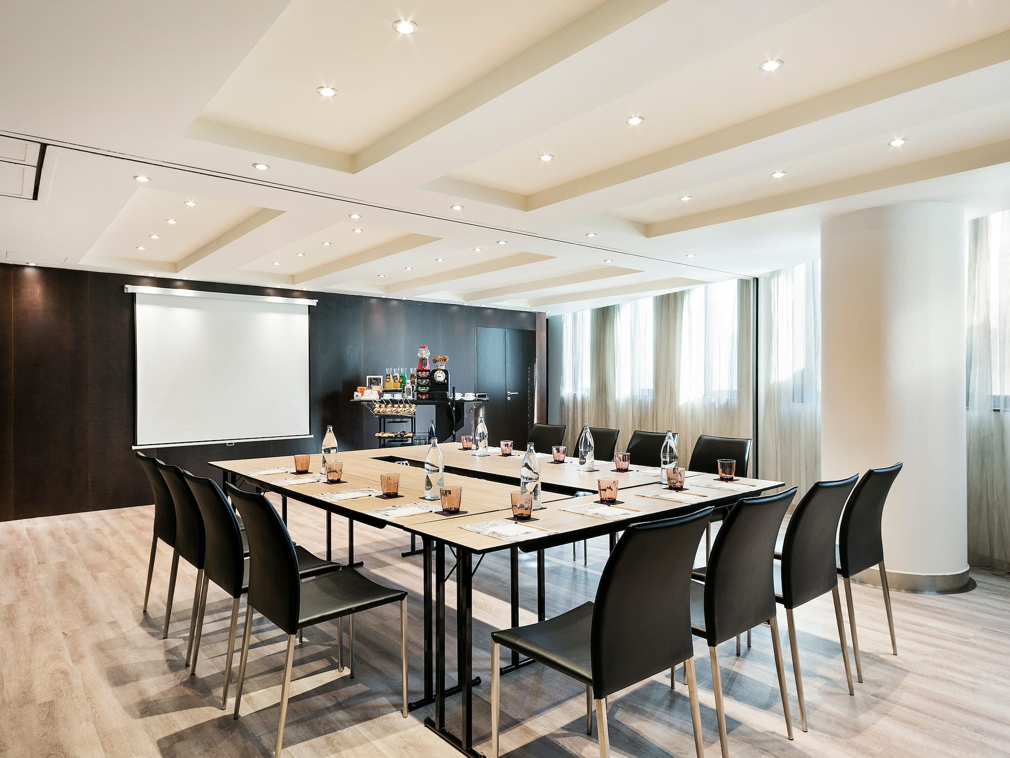 a conference room with a table and chairs