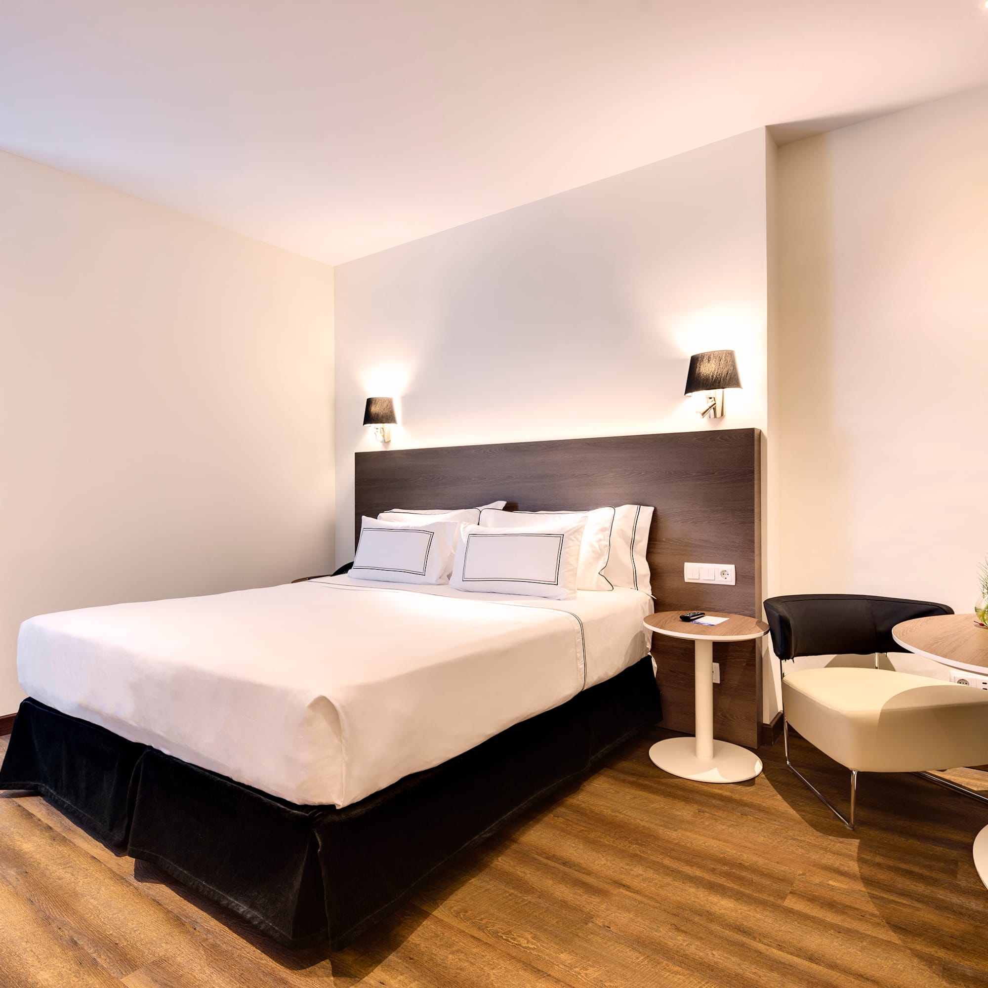 a bedroom with a bed and a table