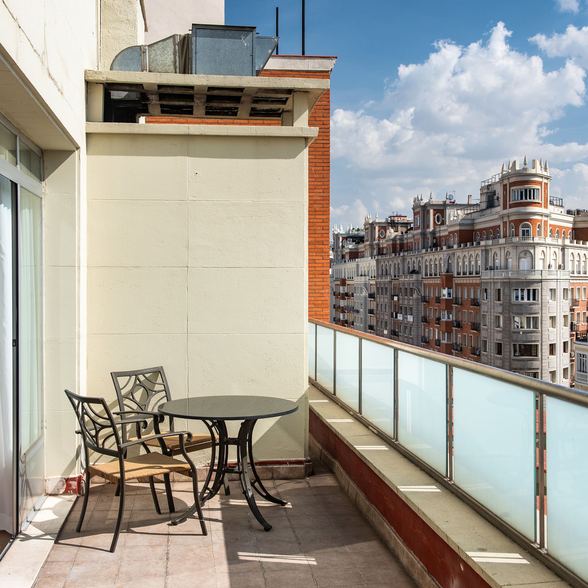 a table and chairs on a balcony
