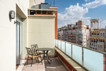 a table and chairs on a balcony