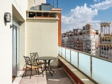 a table and chairs on a balcony