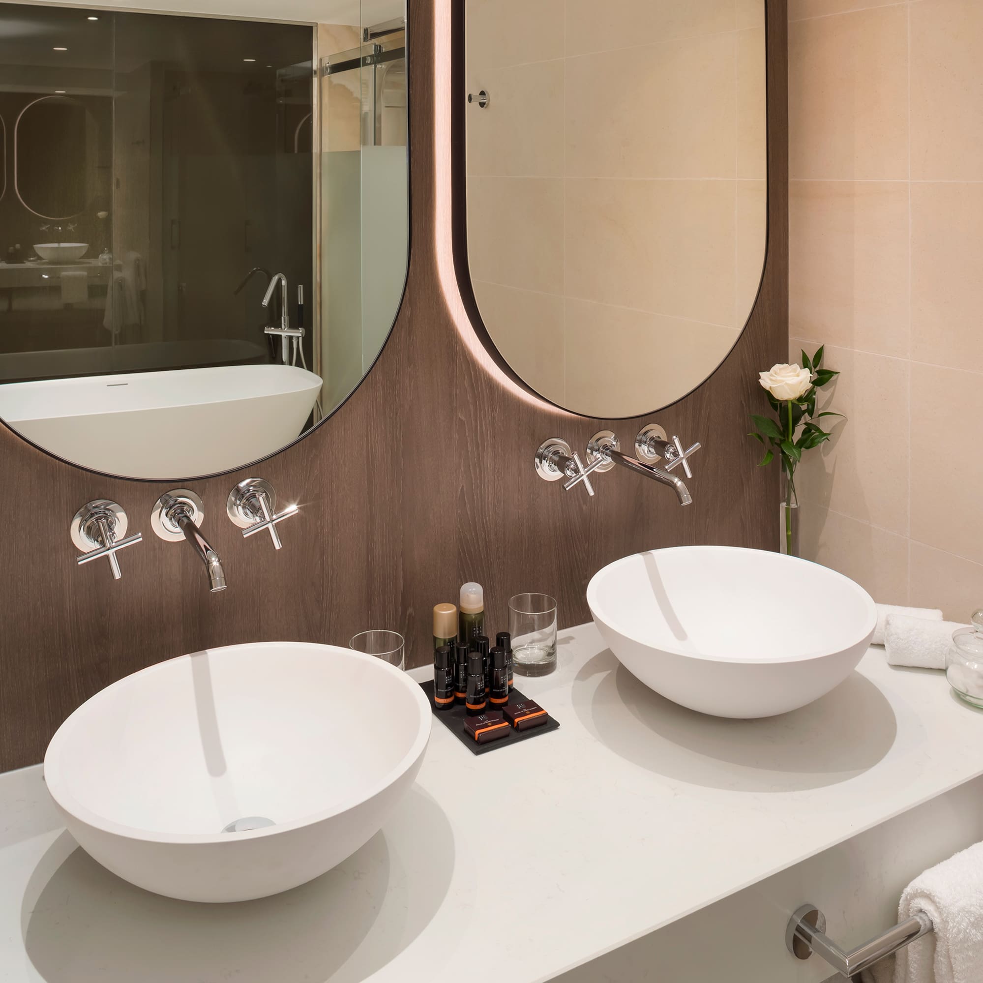 a bathroom with two sinks and a mirror