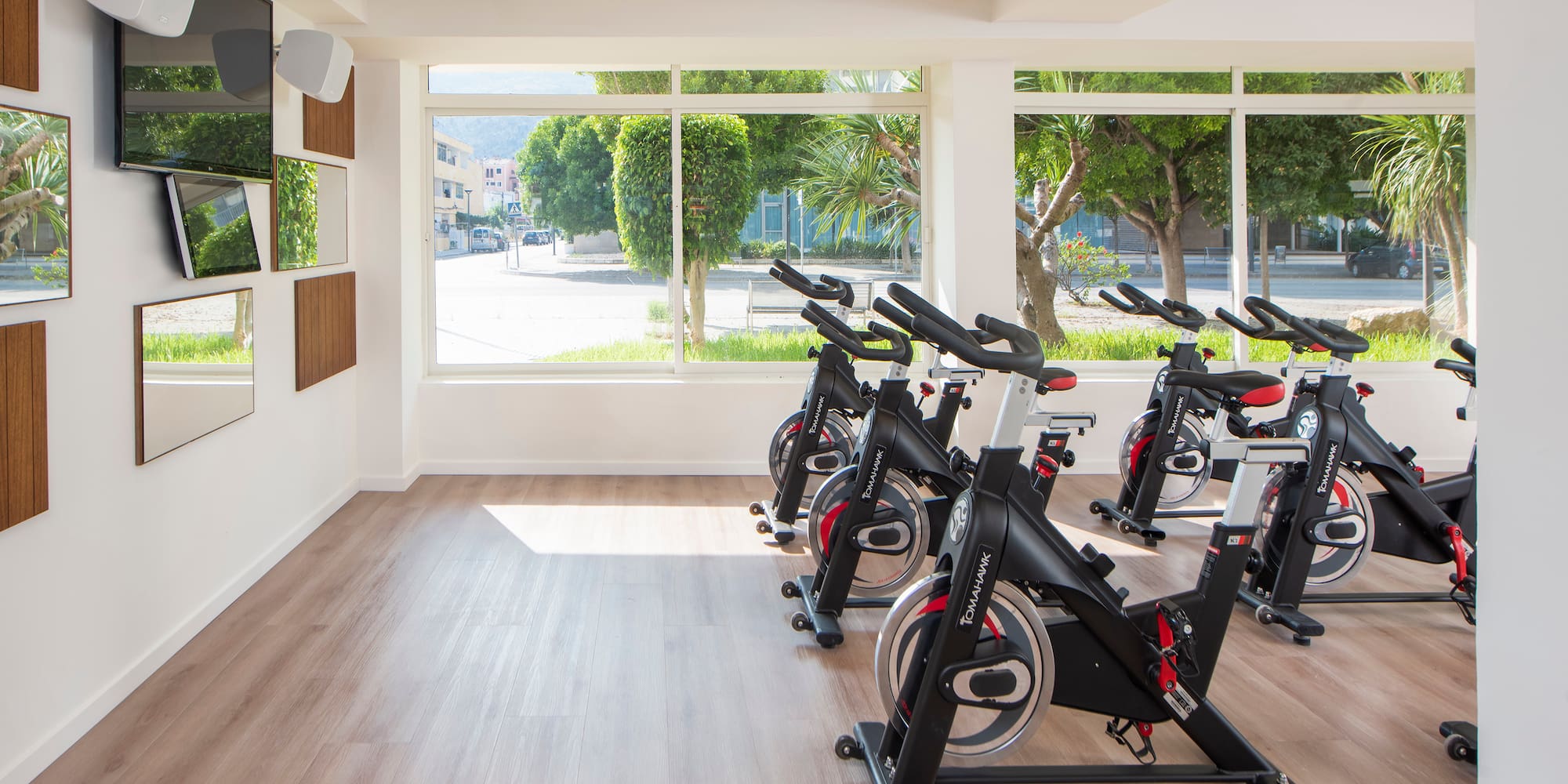 a room with exercise bikes and a large window