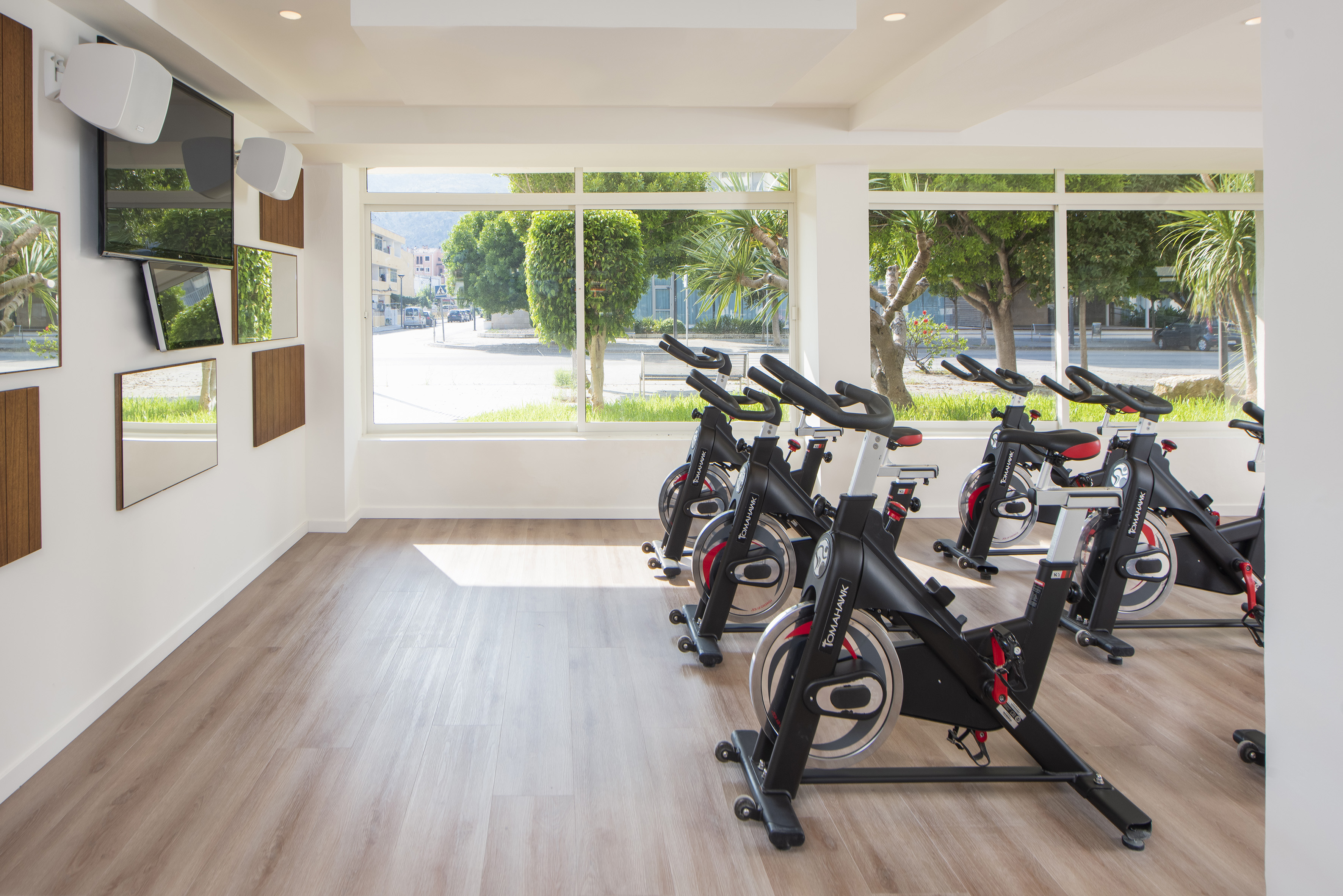a room with exercise bikes and a large window