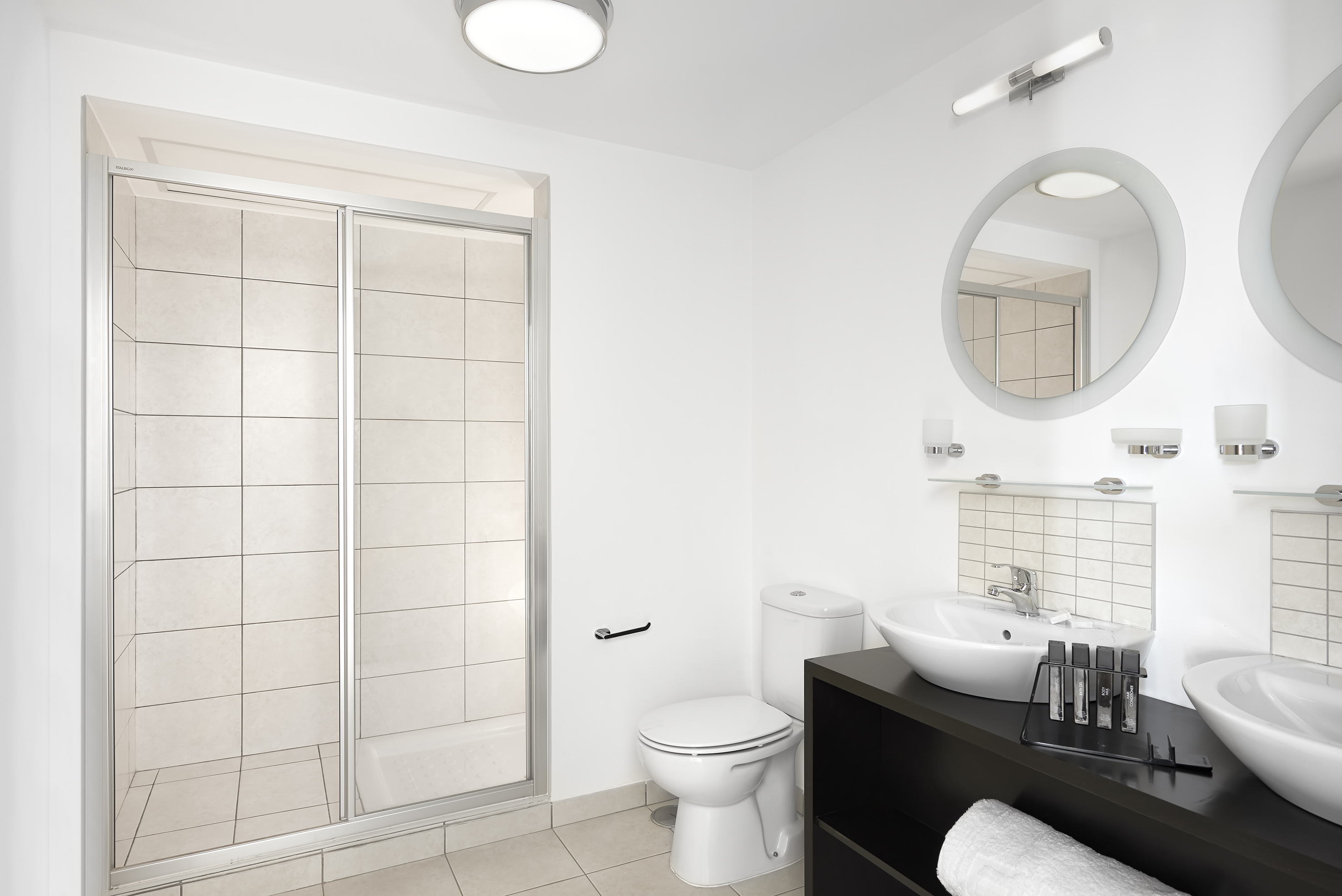 a bathroom with a shower and sink