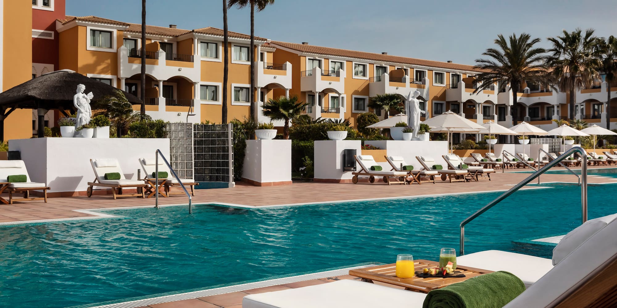 a pool with lounge chairs and a table with food on it