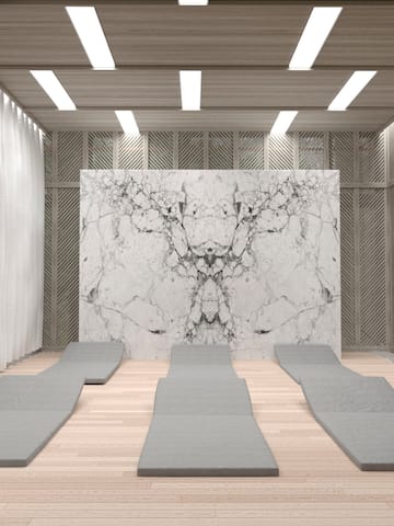a room with mats and a marble wall