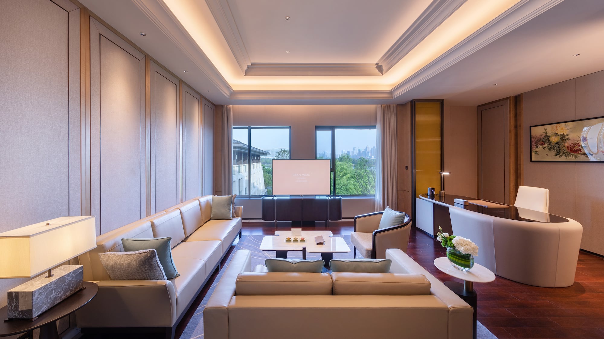 a room with white couches and a tv