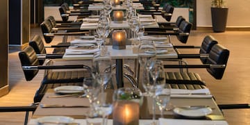 a long table set with wine glasses and candles