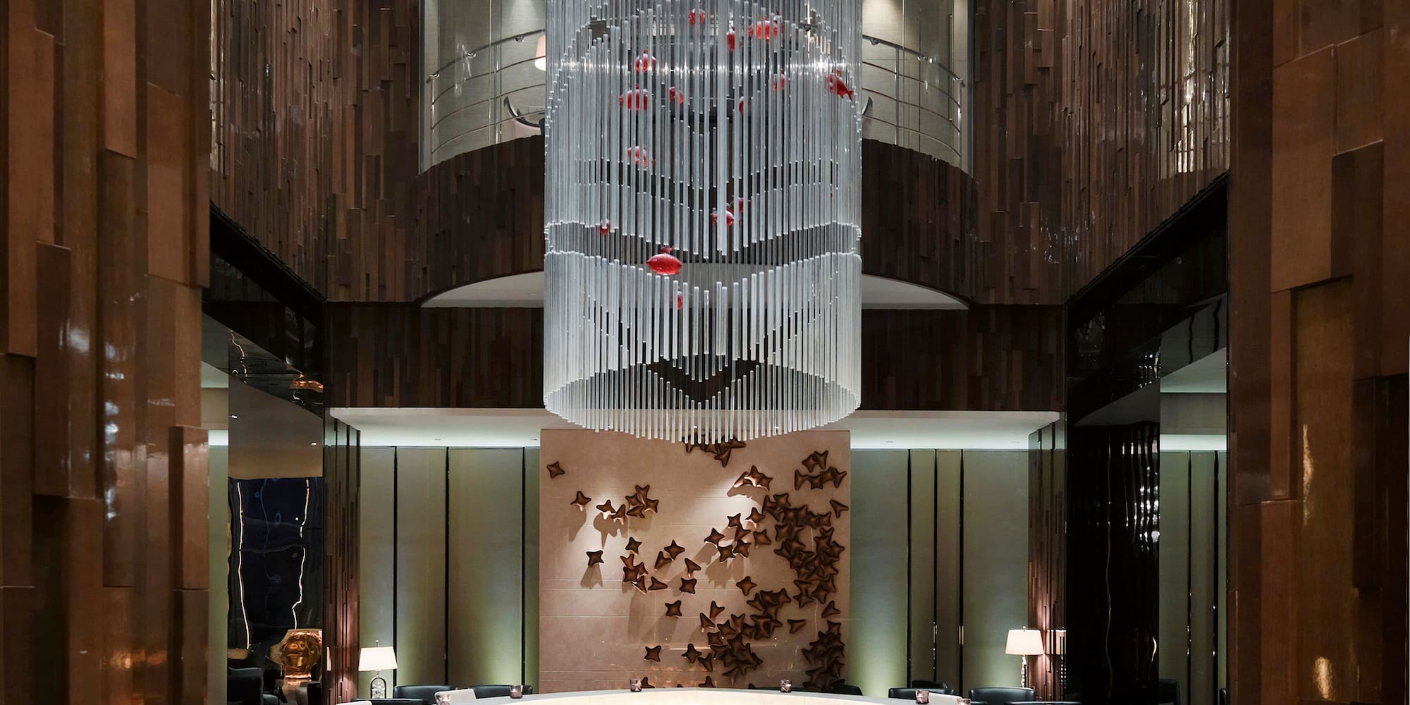 a room with a chandelier and a round table