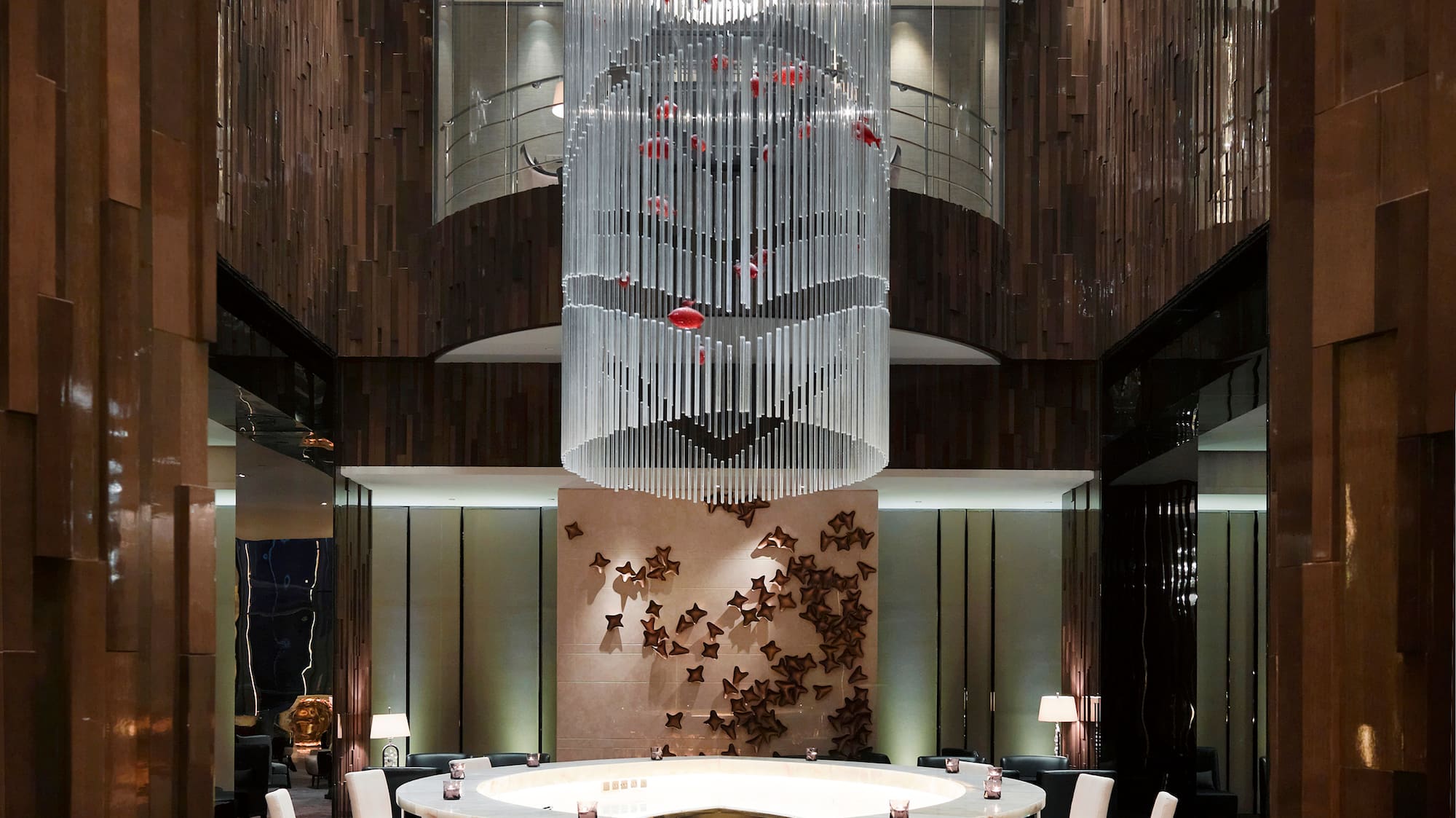 a room with a chandelier and a round table