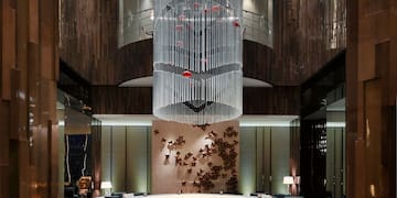 a room with a chandelier and a round table