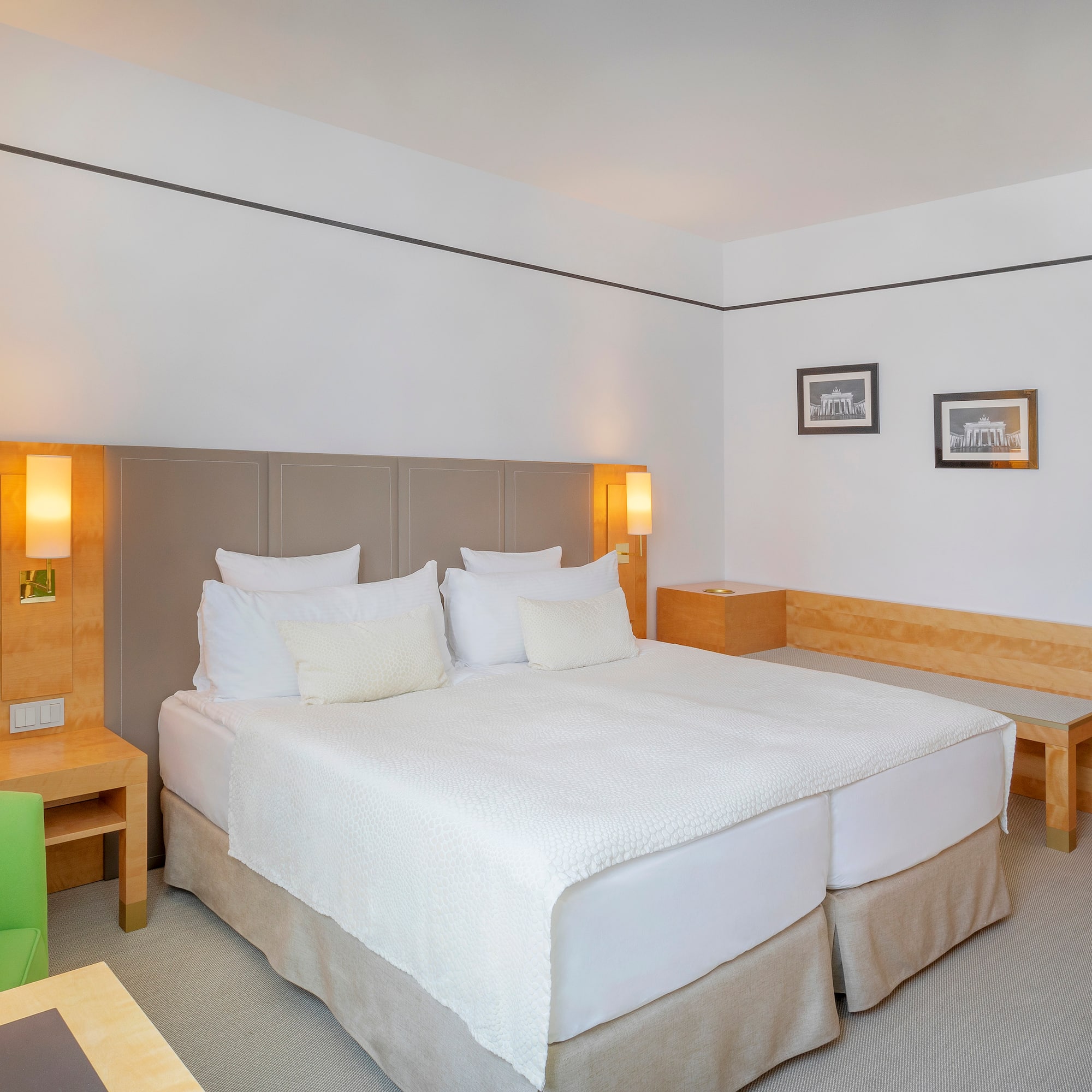 a bed with white sheets and pillows in a room