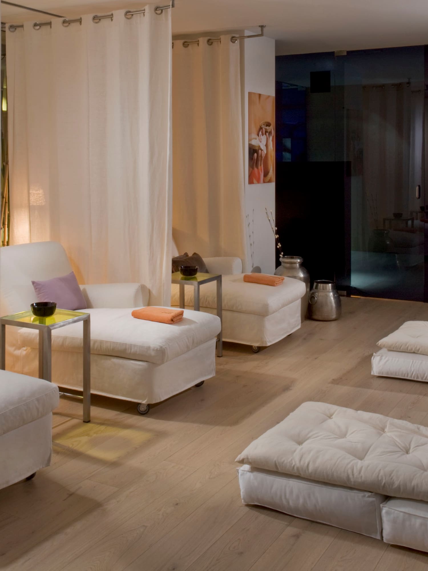 a room with white couches and tables