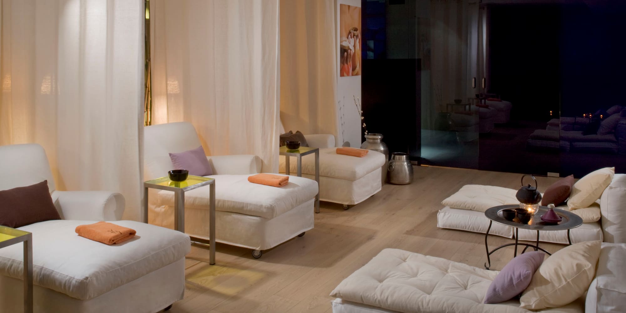 a room with white couches and tables