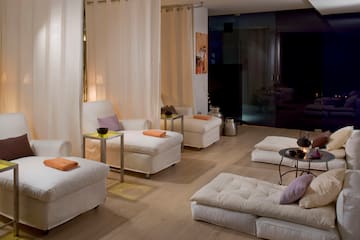 a room with white couches and tables