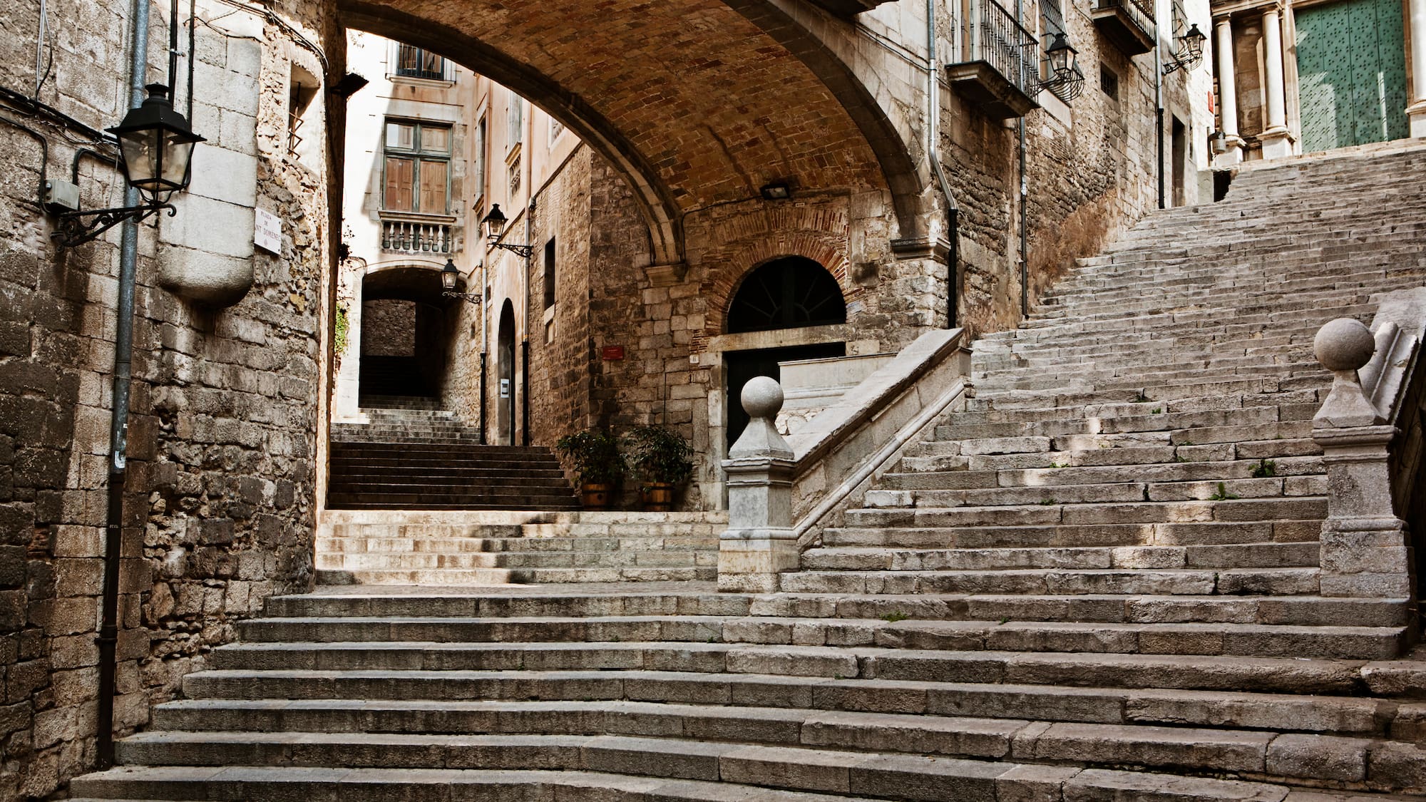 a stone stairs under a bridge