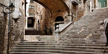 a stone stairs under a bridge