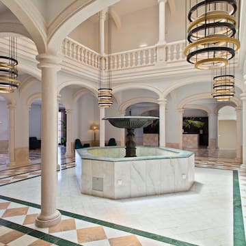 a large room with a fountain and columns