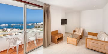 a room with a glass door and a view of the ocean
