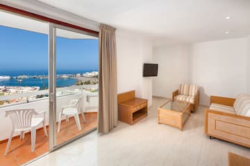 a room with a glass door and a view of the ocean