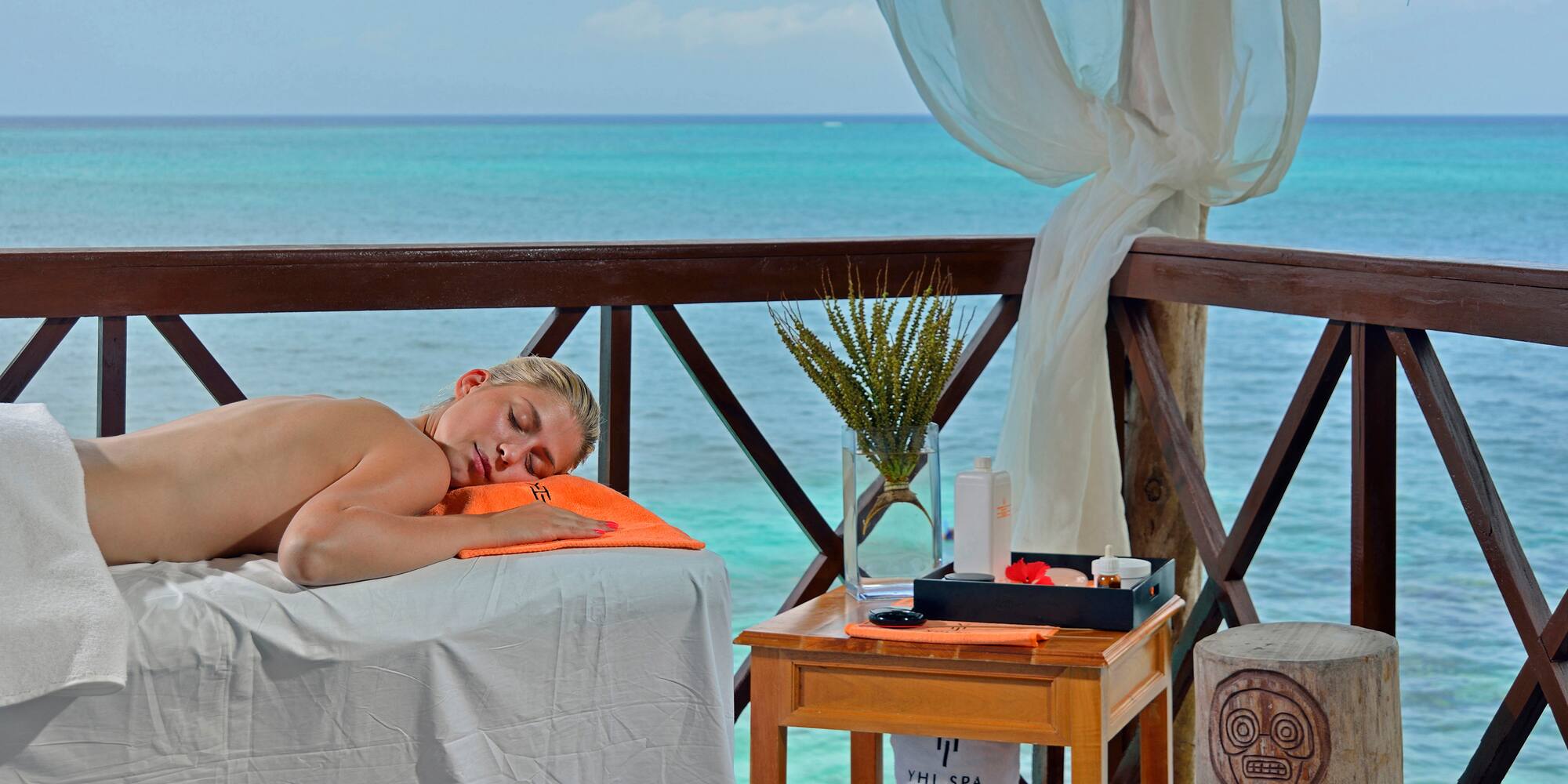 a woman lying on a table with a towel on it