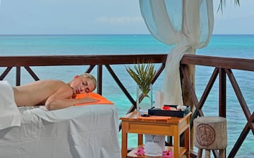 a woman lying on a table with a towel on it