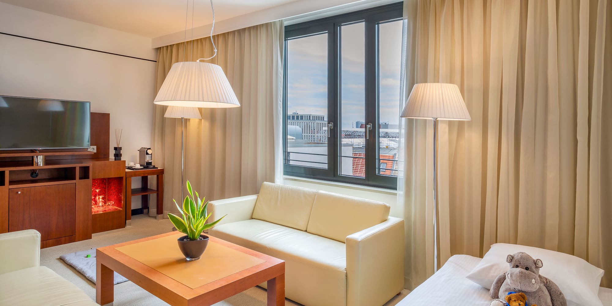 a room with a couch and a table and lamp