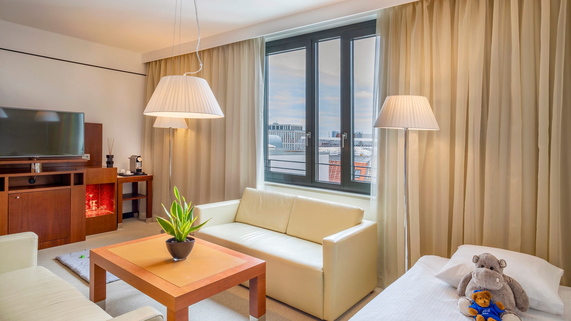 a room with a couch and a table and lamp