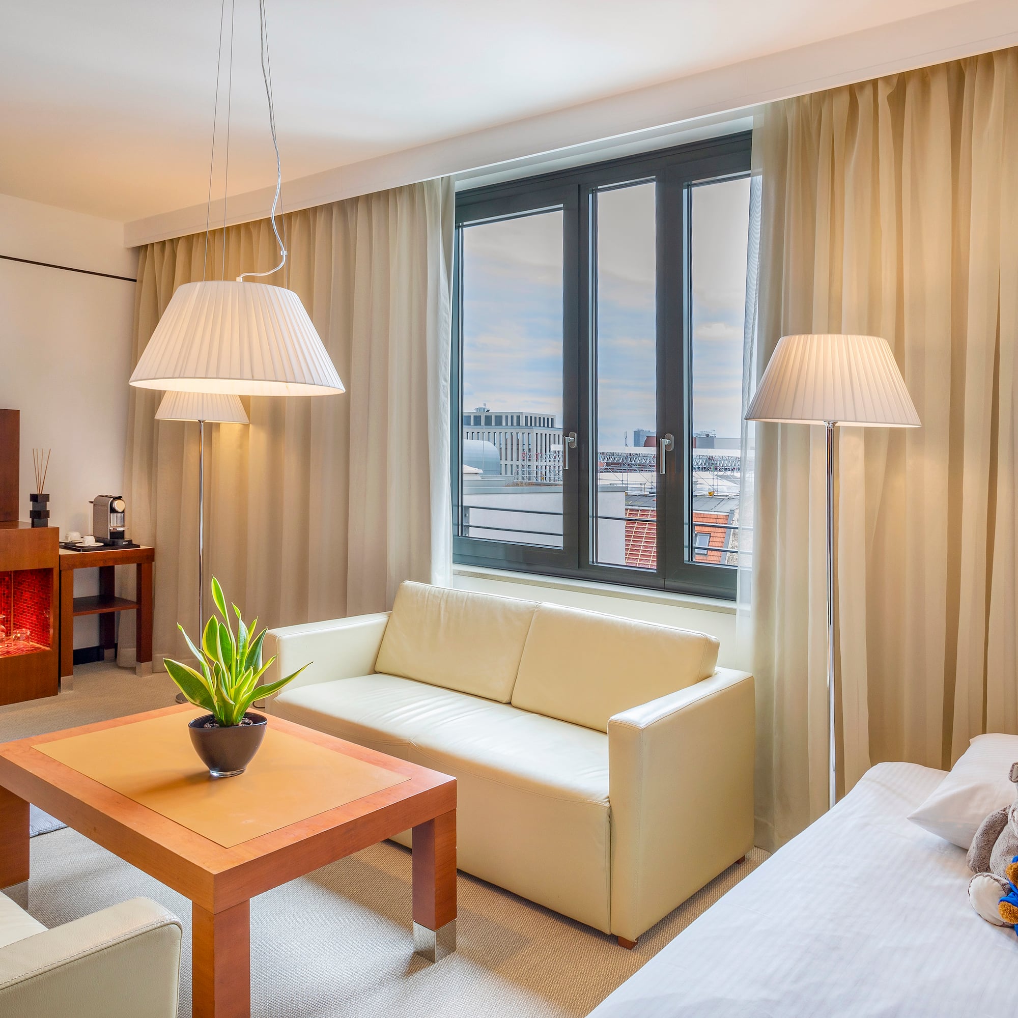 a room with a couch and a table and lamp