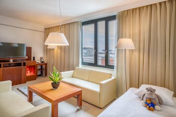 a room with a couch and a table and lamp