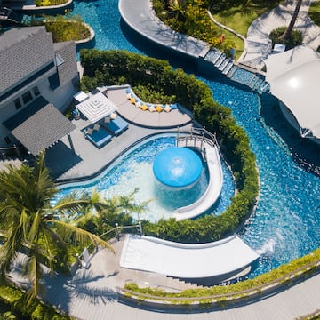 a pool with a slide and a house